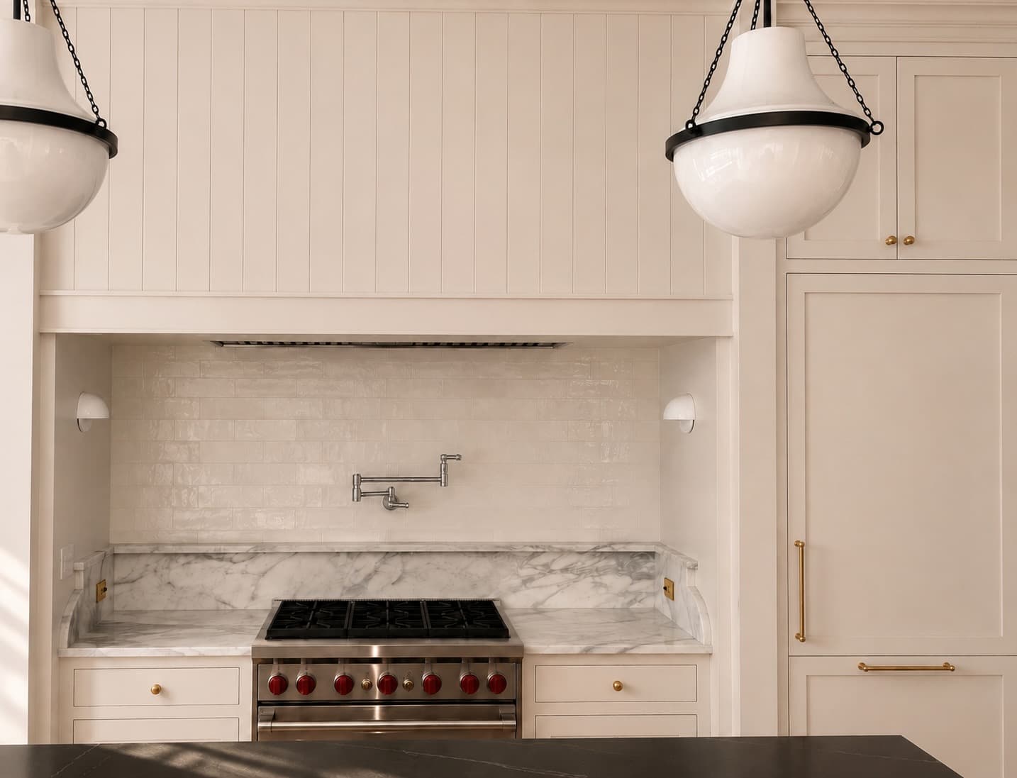 Kitchen range with marble surround and pendant lights